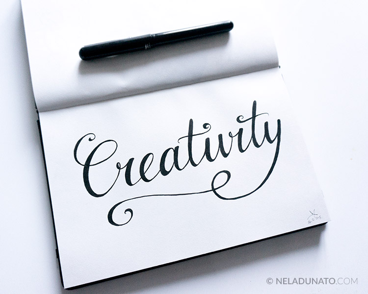 Hand-lettering 'Creativity", brush pen in a sketchbook